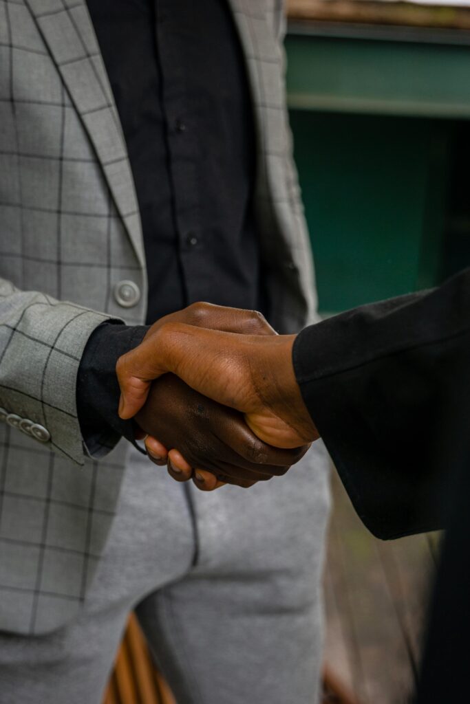 A close-up shot of a professional handshake, symbolizing business agreement and partnership.