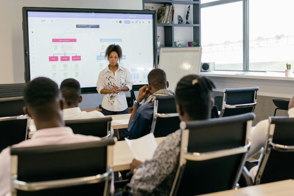 Diverse group of professionals engaged in a presentation in a contemporary office setting.